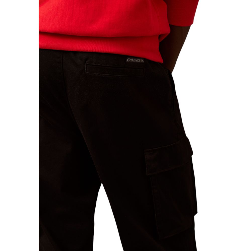 Cargo Pants by Calvin Klein Jeans for men in stretch cotton black features an urban chic straight-leg & regular-fit with a and long, creating a urban chic aesthetic for "Moon Behind the Hill".