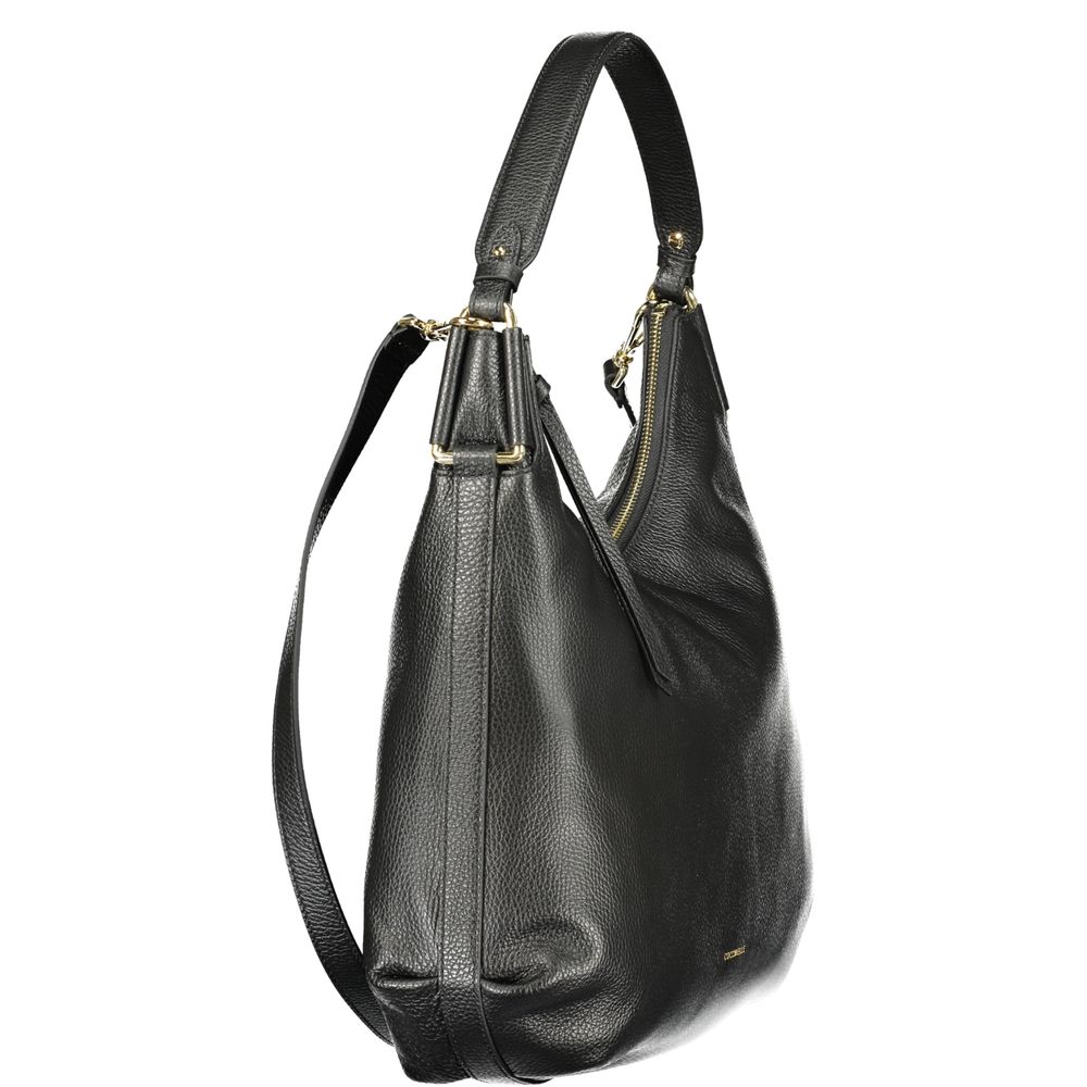 This Handbag by Coccinelle for women in leather and black presents a sculptural silhouette featuring a secure , ample , and versatile for a sculptural finish.
