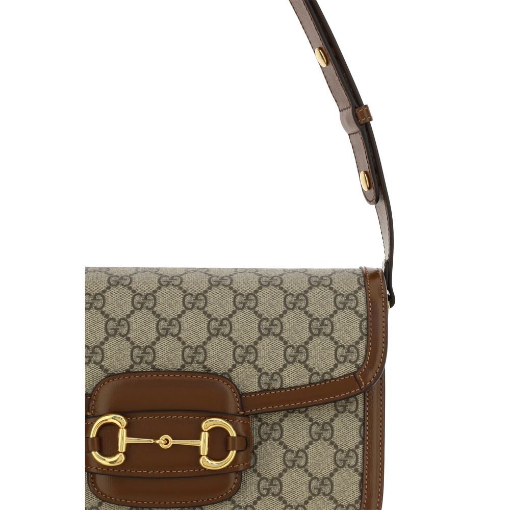 This Shoulder Flap Handbag by Gucci for women in polyester polyurethane leather & cotton and beige, gold, jacquard & print presents a sculptural silhouette featuring a secure flap, ample , and versatile shoulder-strap & adjustable-strap for a sculptural finish.