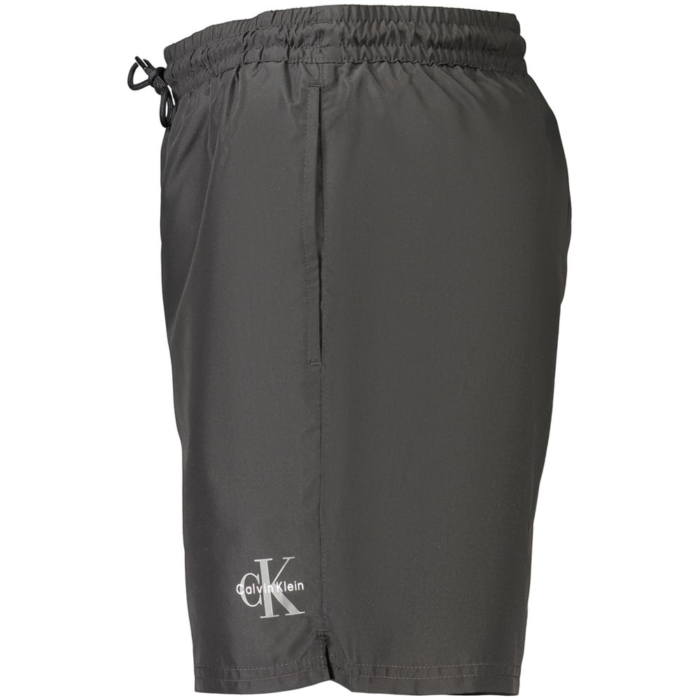 Swim Shorts by Calvin Klein for men in polyester black showcases a sculptural silhouette, expertly capturing the sophisticated essence of the sculptural Waves Men's Polyester Swim Shorts design for a premium poolside look.