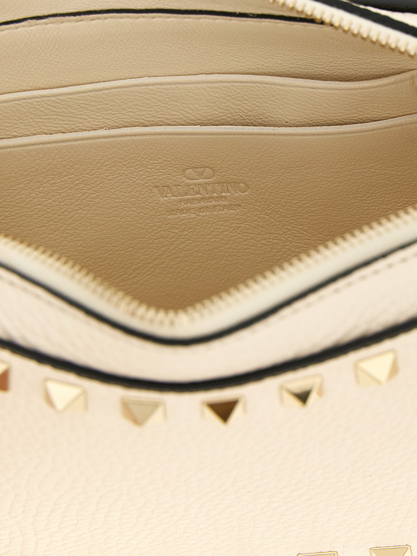 Clutch Handbag by Valentino Garavani for women in calfskin leather white features a statuesque silhouette, showcasing a secure zipper and organized with versatile wristlet & handle for statuesque evening wear.