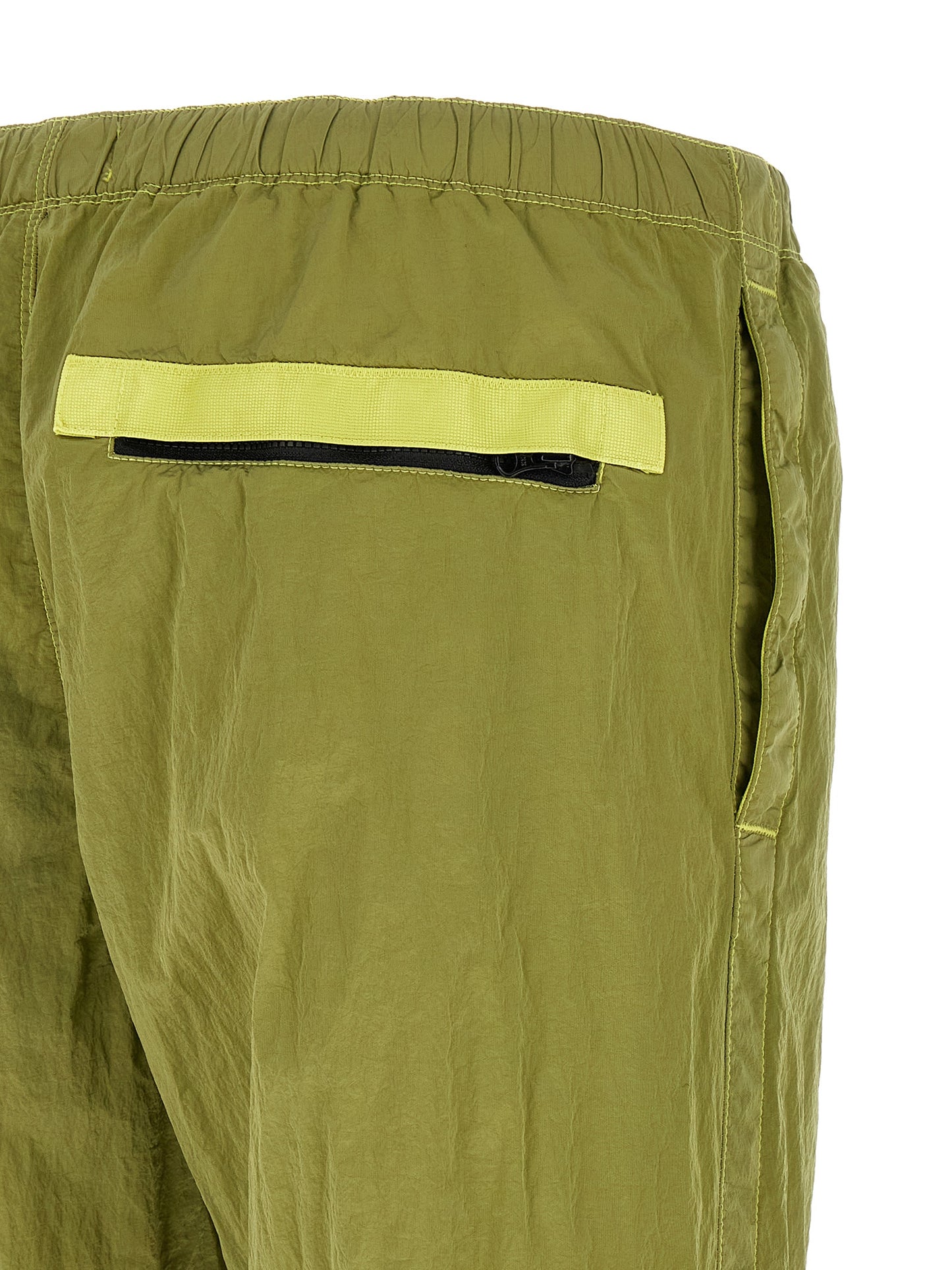 Joggers by Stone Island for men in nylon bicolour & green presents a refined pantology silhouette, artfully defined by a refined pantology tapered-leg, long, and a sophisticated .