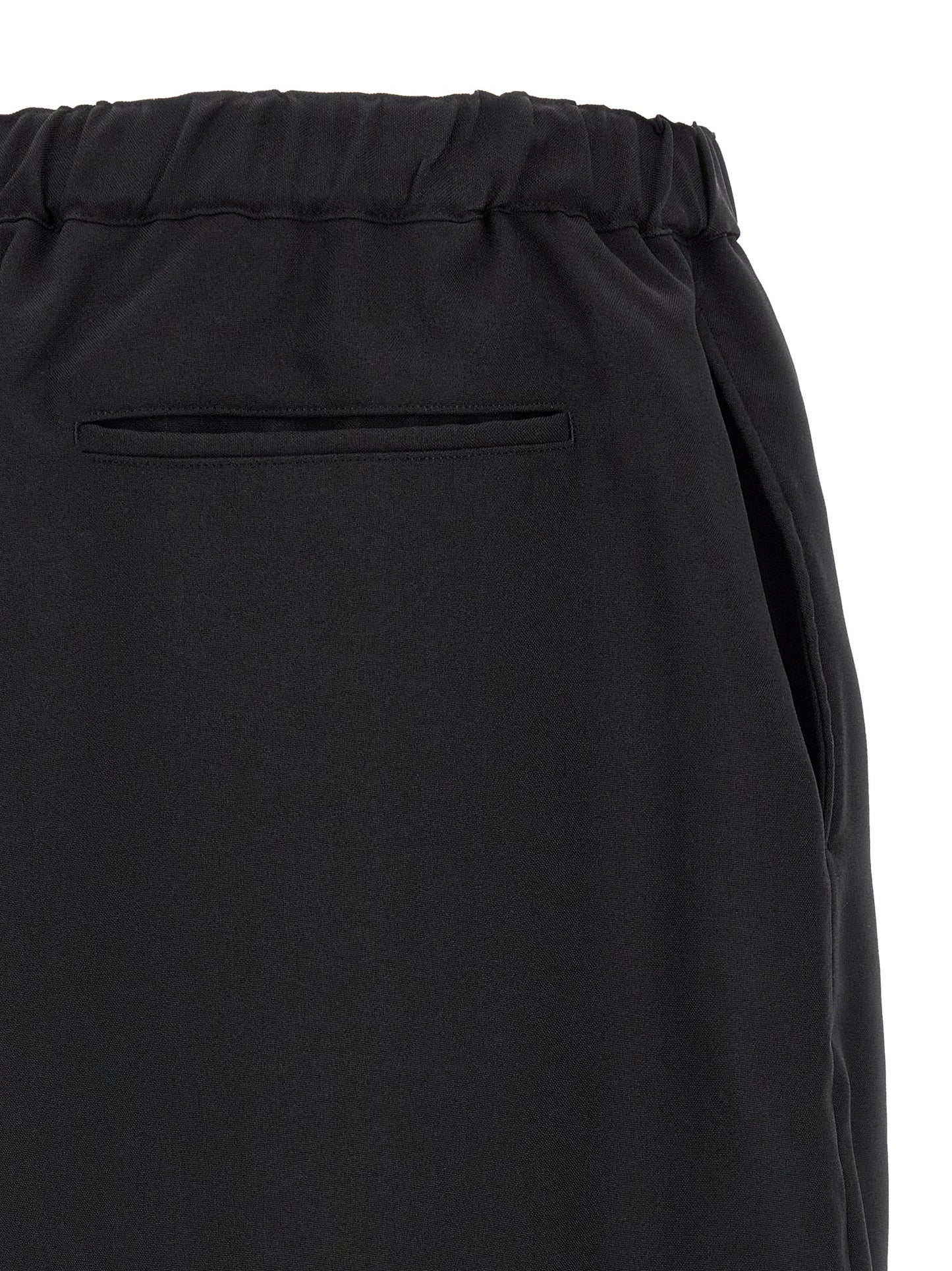 Trousers by Comme Des Garçons for men in polyester black features an sartorial silhouette, showcasing a precise and long with a sartorial for a refined look.