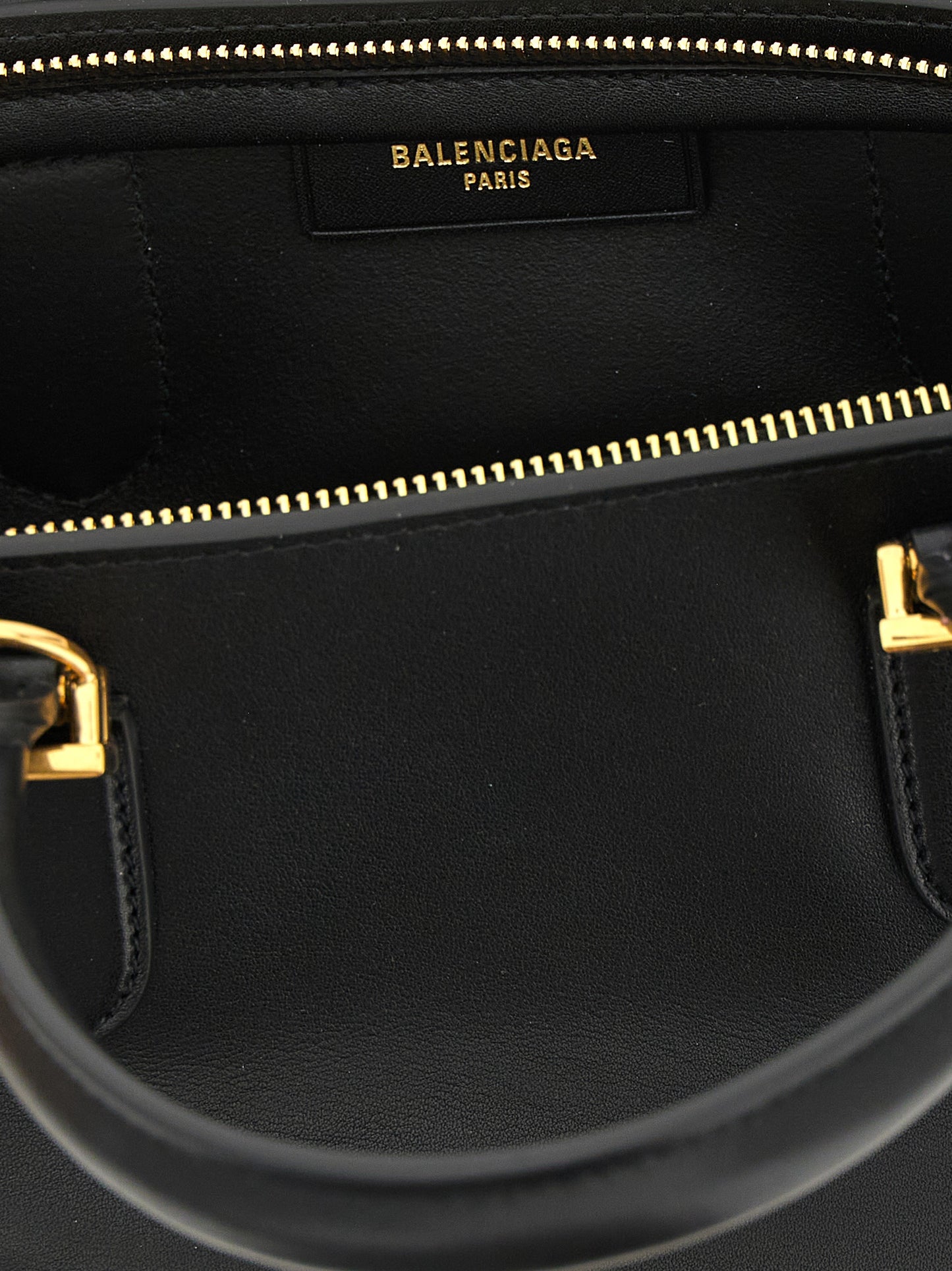 Mini Bowling Handbag by Balenciaga for women in calfskin leather black features an refined silhouette, showcasing a secure zipper, ample , and versatile shoulder-strap & adjustable-strap for a sophisticated refined aesthetic.
