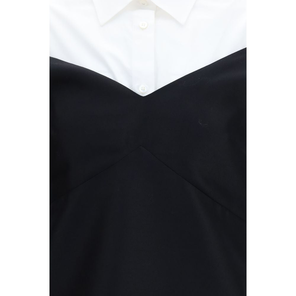 Dress by Balenciaga for women in silk & merino wool black & pearl features a dramatic silhouette, showcasing an elegant and that flows into a dramatic short mini.