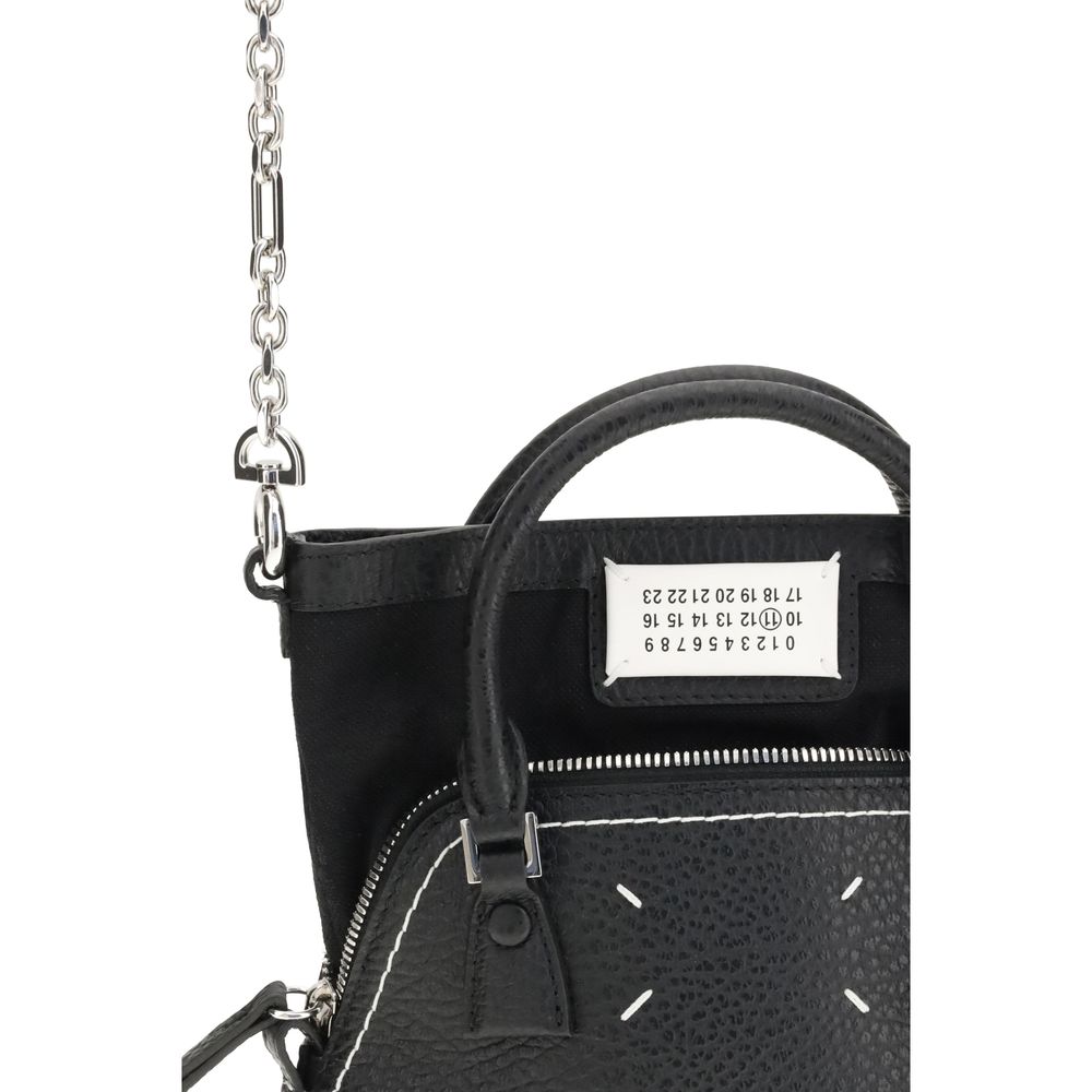 Shoulder Bag by Maison Margiela for women in bos taurus calf leather black, signature & monogram features a effortless chic silhouette with a secure zipper, ample internal-pockets, and versatile shoulder-strap, handle & adjustable-strap for a effortless chic finish.