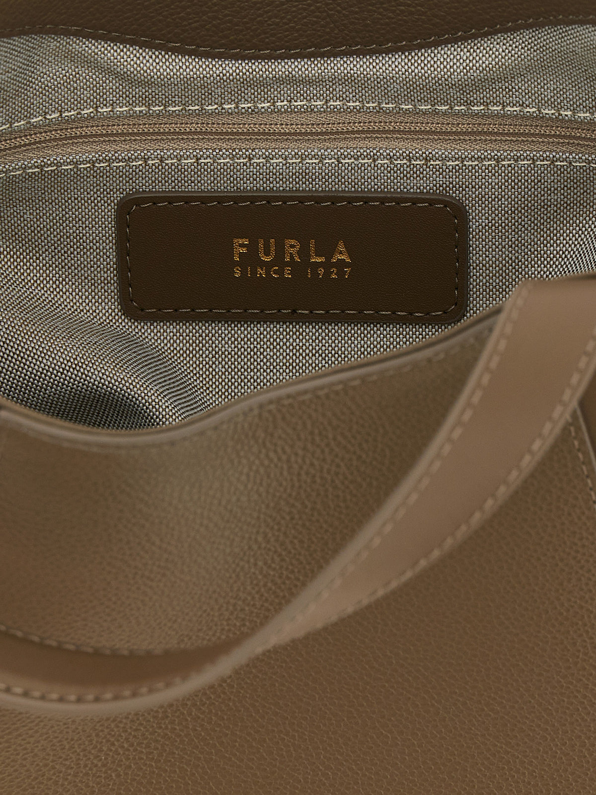 Crossbody Tote Bag by Furla for women in bos taurus suede calf leather gray & gold features an utilitarian-chic silhouette, showcasing the Goccia Bos Taurus Suede Calf Leather Crossbody Tote Bag design with a secure , ample , and versatile crossbody-strap, shoulder-strap, handle, adjustable-strap & detachable-strap.