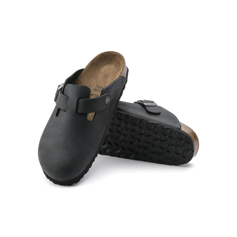 Mules Sandals Flat Shoes by Birkenstock for women in latex & cork black & natural showcases a dynamic silhouette, artfully capturing Icon Women's Latex & Cork Mules Sandals Flat Shoes through its distinctive and elegant .