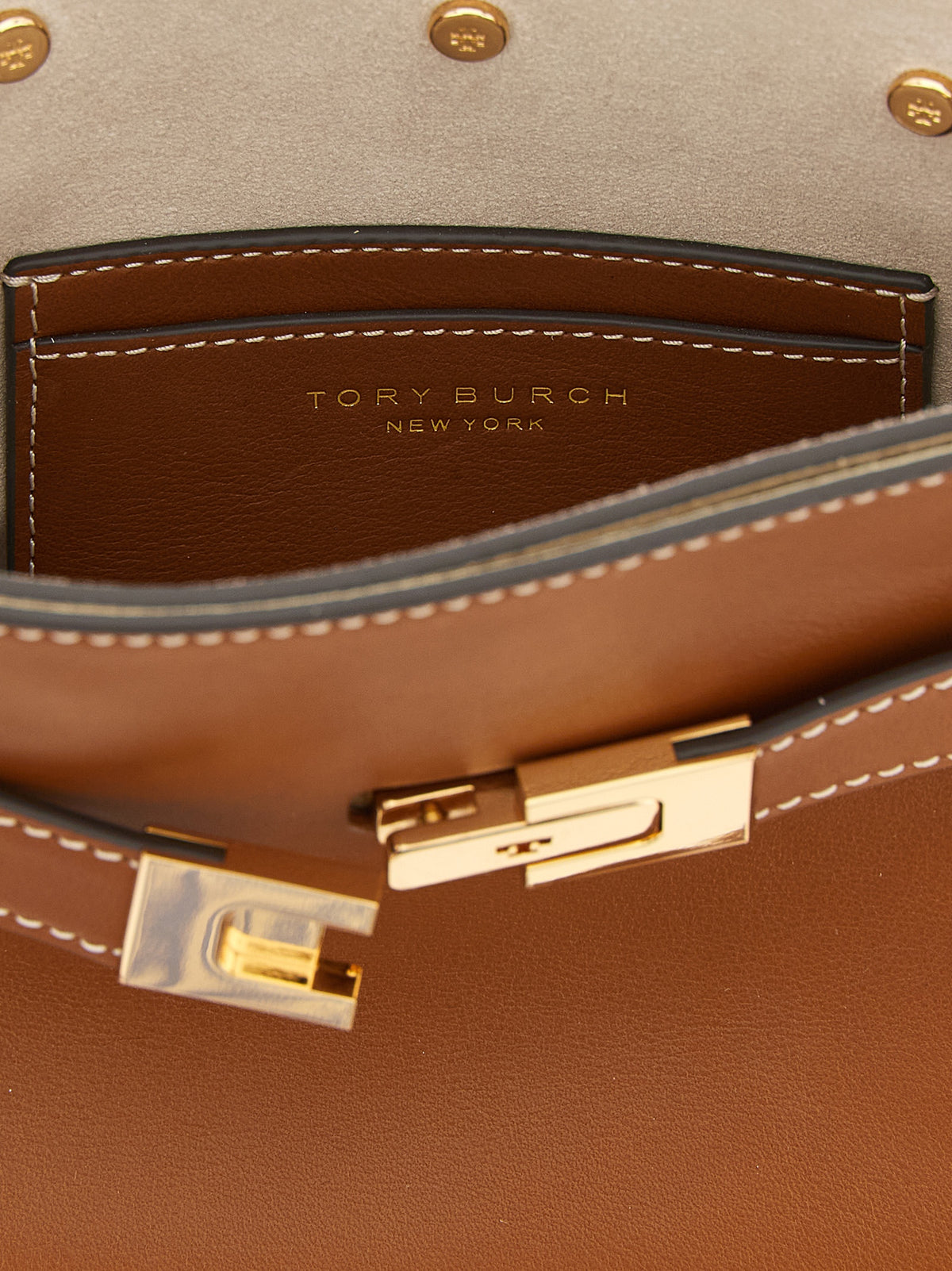 Compact Crossbody Handbag by Tory Burch for women in cowhide leather brown, gold & signature features a versatile chic silhouette, meticulously detailed with a secure , ample , and versatile crossbody-strap, shoulder-strap, handle, adjustable-strap, detachable-strap & belt-strap.