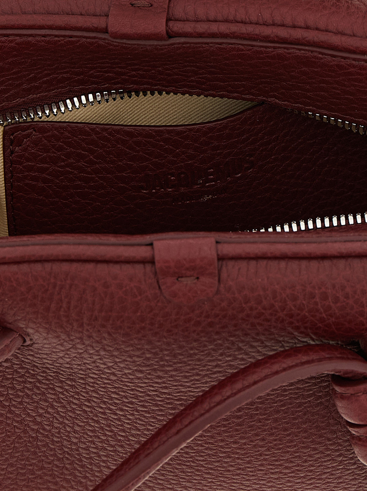 Bowling Handbag by Jacquemus for women in calfskin leather bordeaux & silver features a refined silhouette, showcasing a secure zipper, organized , and versatile handle & adjustable-strap for a refined finish.
