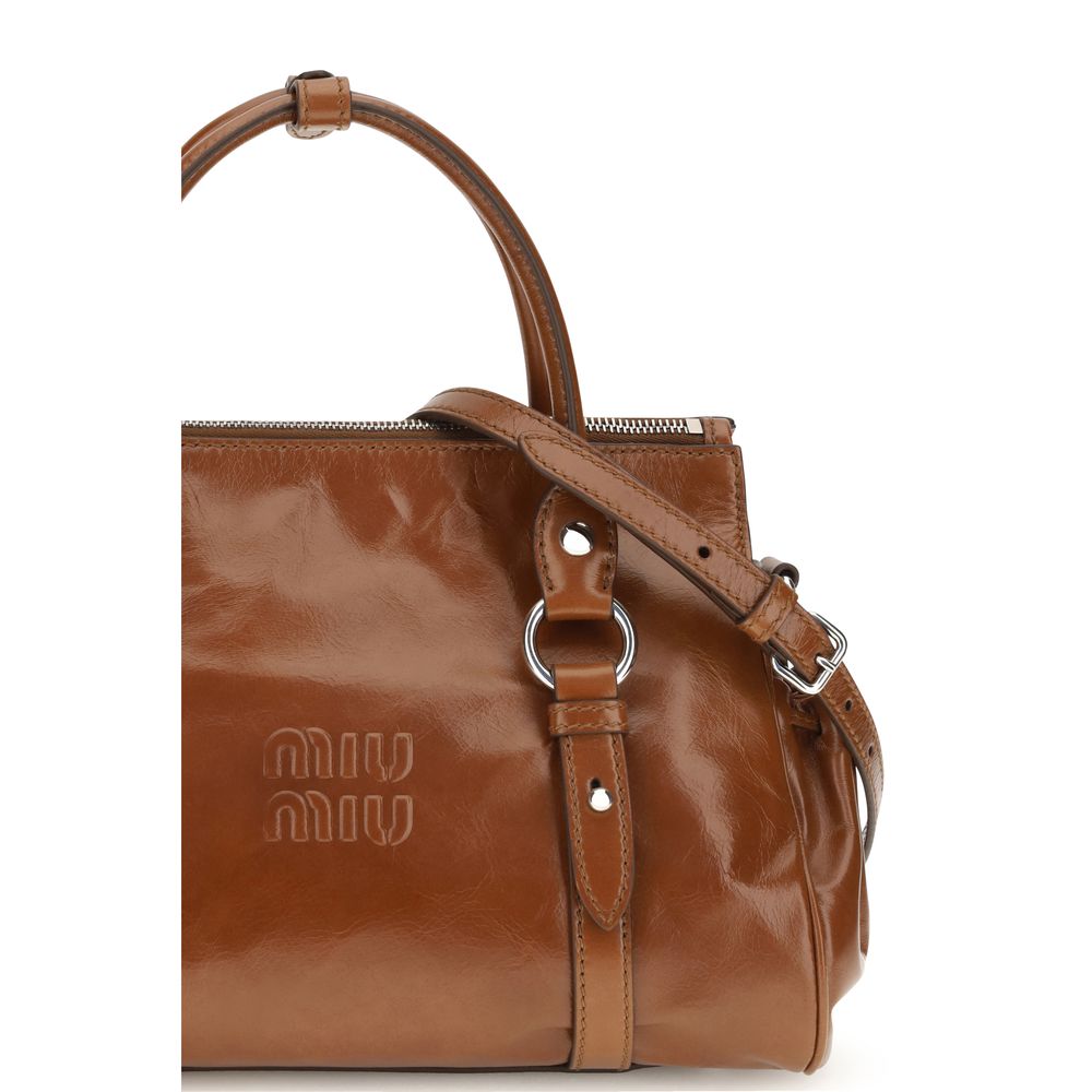 Handbag by Miu Miu for women in bos taurus calf leather & steel brown features a contemporary silhouette, showcasing a secure zipper, ample , and contemporary shoulder-strap, adjustable-strap & handle for a sophisticated look.