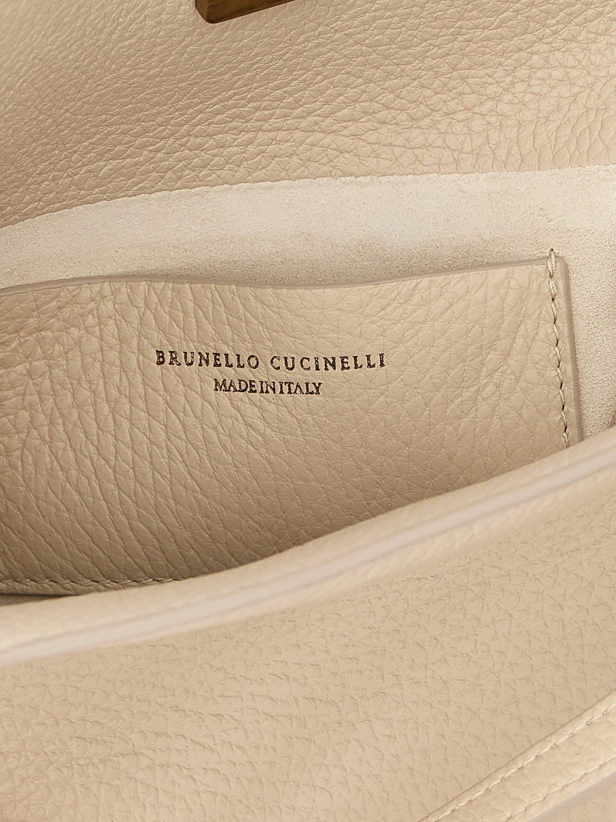 Bucket Handbag by Brunello Cucinelli for women in suede leather beige features a signature silhouette, showcasing a secure magnetic and signature internal-pockets & cardholder with versatile shoulder-strap, handle, adjustable-strap & detachable-strap for a sophisticated look.