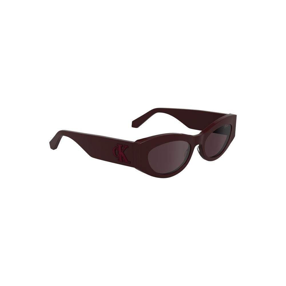 Sunglasses by Calvin Klein for women in brown & red features an lustrous cat-eye frame design with red coloured frame detailing and for a lustrous aesthetic.