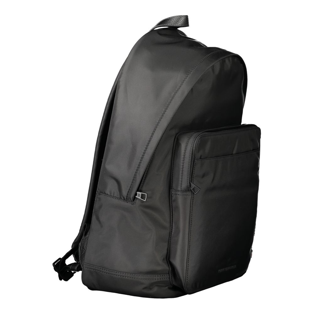 Backpack by Tommy Hilfiger for men in polyester black features a stately Polyester Backpack design, showcasing a secure zipper, ample external-pockets, internal-pockets & laptop-compartment, and versatile handle, backpack-strap & adjustable-strap for a stately finish.