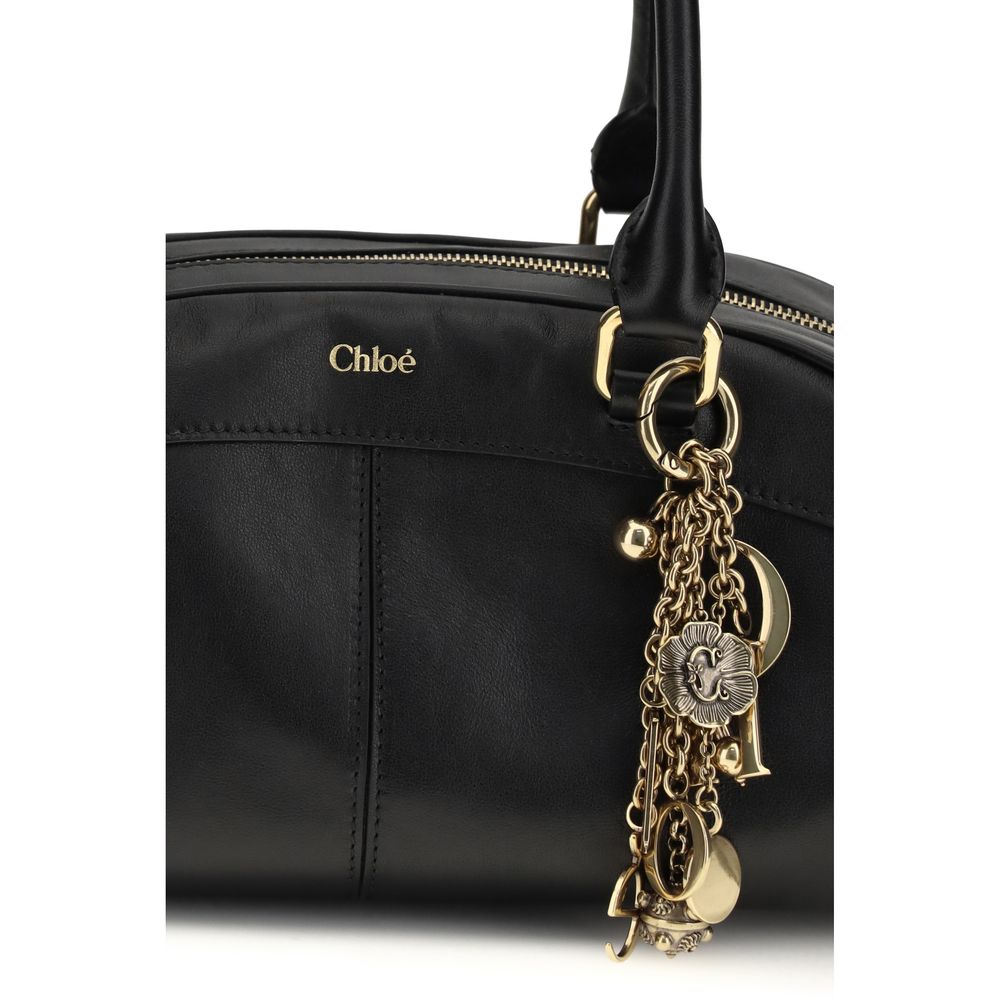 Large Shoulder Bowling Bag by Chloé for women in bos taurus calfskin leather black features an effortlessly chic silhouette with a secure zipper, ample , and versatile shoulder-strap & handle for effortlessly chic everyday luxury.