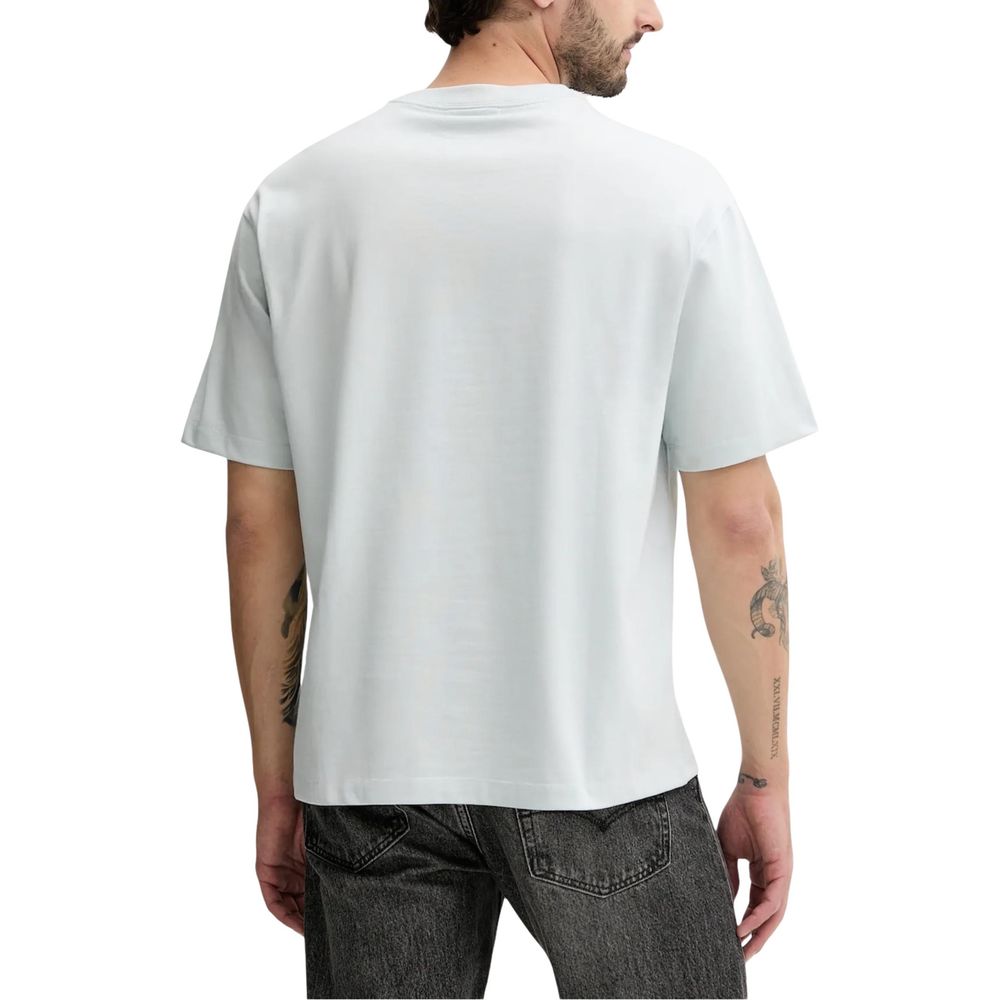 T-Shirt by Calvin Klein Jeans for men in cotton blue showcases a unassuming silhouette, artfully detailed with a refined and unassuming for a sophisticated, contemporary look.