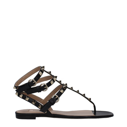 Flat Flip-Flop Sandals by Valentino Garavani for women in leather and black & gold presents a captivating silhouette, showcasing the signature style of the Women's Leather Flat Flip-Flop Sandals with a captivating flat and captivating open toe style.