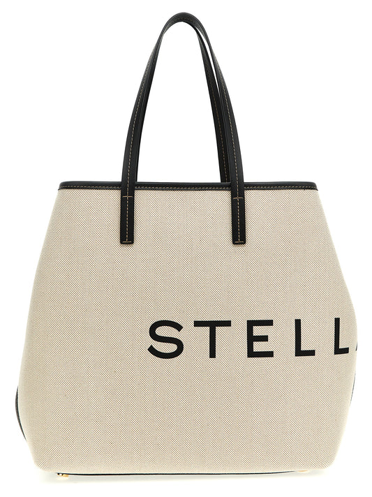 This Shopper Tote Clutch Bag by Stella McCartney for women in cotton polyester canvas beige & print features an jet-set Cotton Polyester Canvas Shopper Tote Clutch Bag design with a secure , ample , and jet-set handle.