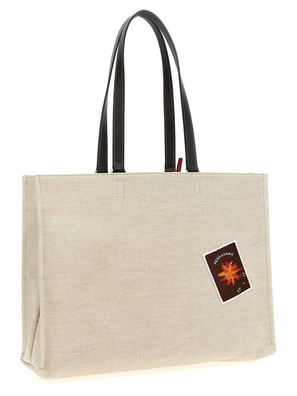 Tote Bag by Ferragamo for women in calfskin leather beige & jacquard features a jet-set Calfskin Leather Tote Bag design, complete with a secure , ample , and versatile handle for a jet-set look.