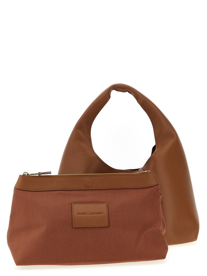 Medium Shoulder Clutch Bag by Marc Jacobs for women in bos taurus calf suede leather brown features a effortless sophistication silhouette, secured by a magnetic with ample and versatile shoulder-strap & handle for a effortless sophistication finish.