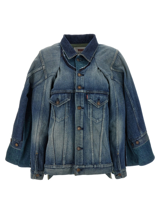 Trucker Jacket by Junya Watanabe for women in denim cotton blue & patchwork features a city-ready silhouette, detailed with pockets and a city-ready asymmetric neckline.