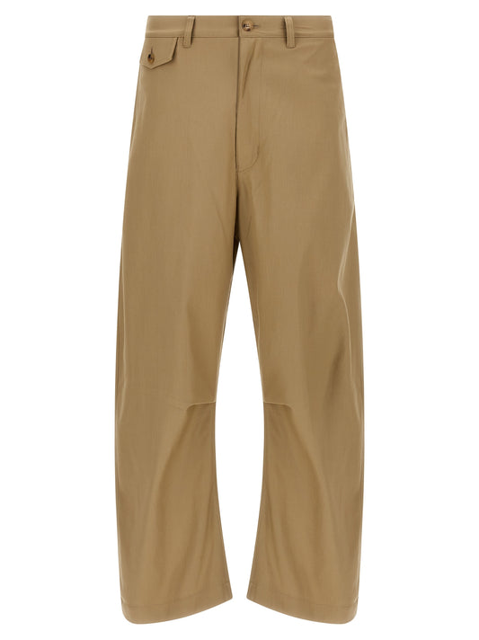 Trousers by Comme Des Garçons for men in cotton beige features a artisanal silhouette, showcasing a sophisticated with a long and for a artisanal finish.