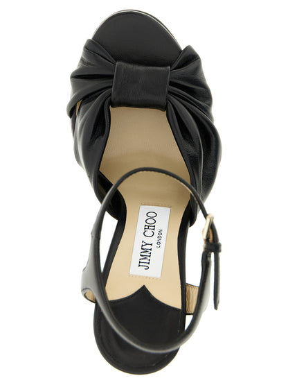 Platform Stiletto Ankle Strap Sandals by Jimmy Choo for women in leather & satin black features an exquisite silhouette, showcasing the exquisite Women's Leather & Satin Platform Stiletto Ankle Strap Sandals with a stiletto platform and .