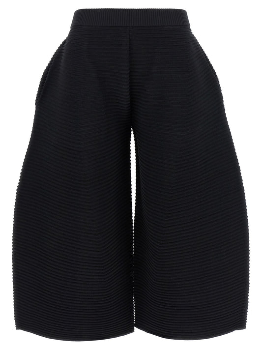 Trousers by Issey Miyake for women in polyester & nylon black features a artisanal silhouette, showcasing a sophisticated wide & cropped with a cropped and for a artisanal finish.
