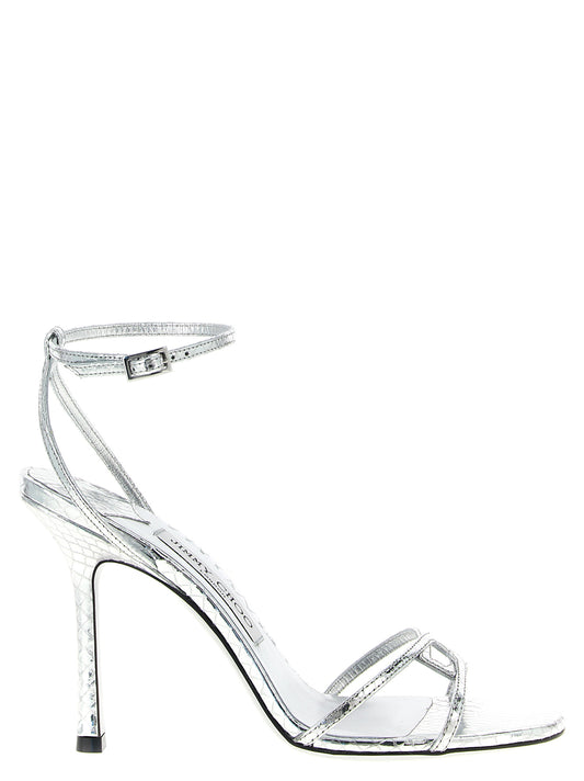 Stiletto Ankle Strap Sandals by Jimmy Choo for women in silk plastic leather silver presents a sculptural silhouette, showcasing the Women's Silk Plastic Leather Stiletto Ankle Strap Sandals design with a sculptural stiletto and for a premium look.