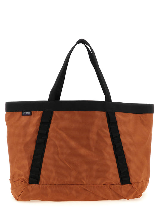 Shopper Tote Bag by Gramicci for men in nylon fabric orange features an jet-set-ready silhouette, showcasing the Nylon Fabric Shopper Tote Bag design with a secure , ample , and versatile handle.
