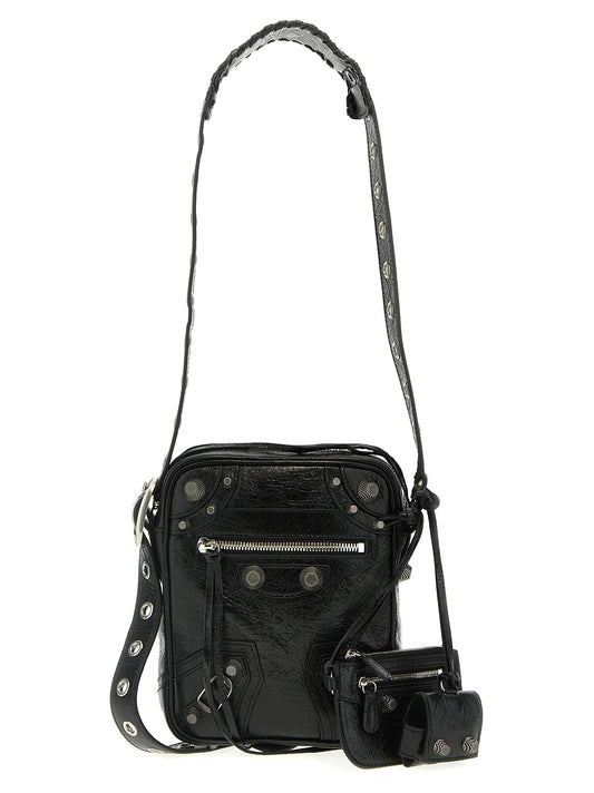 This Crossbody Messenger Clutch Bag by Balenciaga for men in polyester & lamb leather black presents a versatile silhouette from the Le Cagole Polyester & Lamb Leather Crossbody Messenger Clutch Bag collection, featuring a secure zipper, ample , and versatile crossbody-strap, shoulder-strap & adjustable-strap.