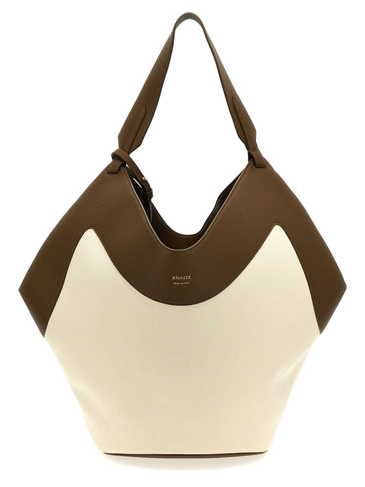 This Tote Clutch Bag by Khaite for women in calfskin canvas & leather multicolor features an on trend Lotus Calfskin Canvas & Leather Tote Clutch Bag design with a secure , ample , and on trend handle.