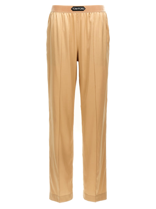 Trousers by Tom Ford for women in silk velvet beige presents a perennial silhouette, meticulously tailored with a straight-leg cut, long finish, and an elegant .