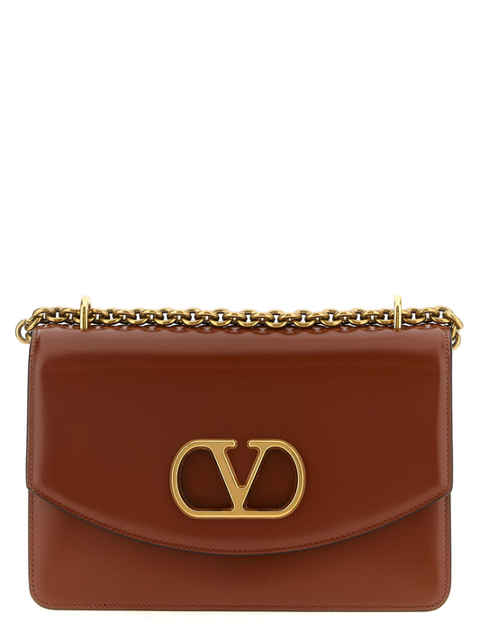 Shoulder Flap Bag by Valentino Garavani for women in nappa calfskin leather brown & signature features a effortless chic silhouette with a secure flap & magnetic, ample , and versatile shoulder-strap for a effortless chic finish.