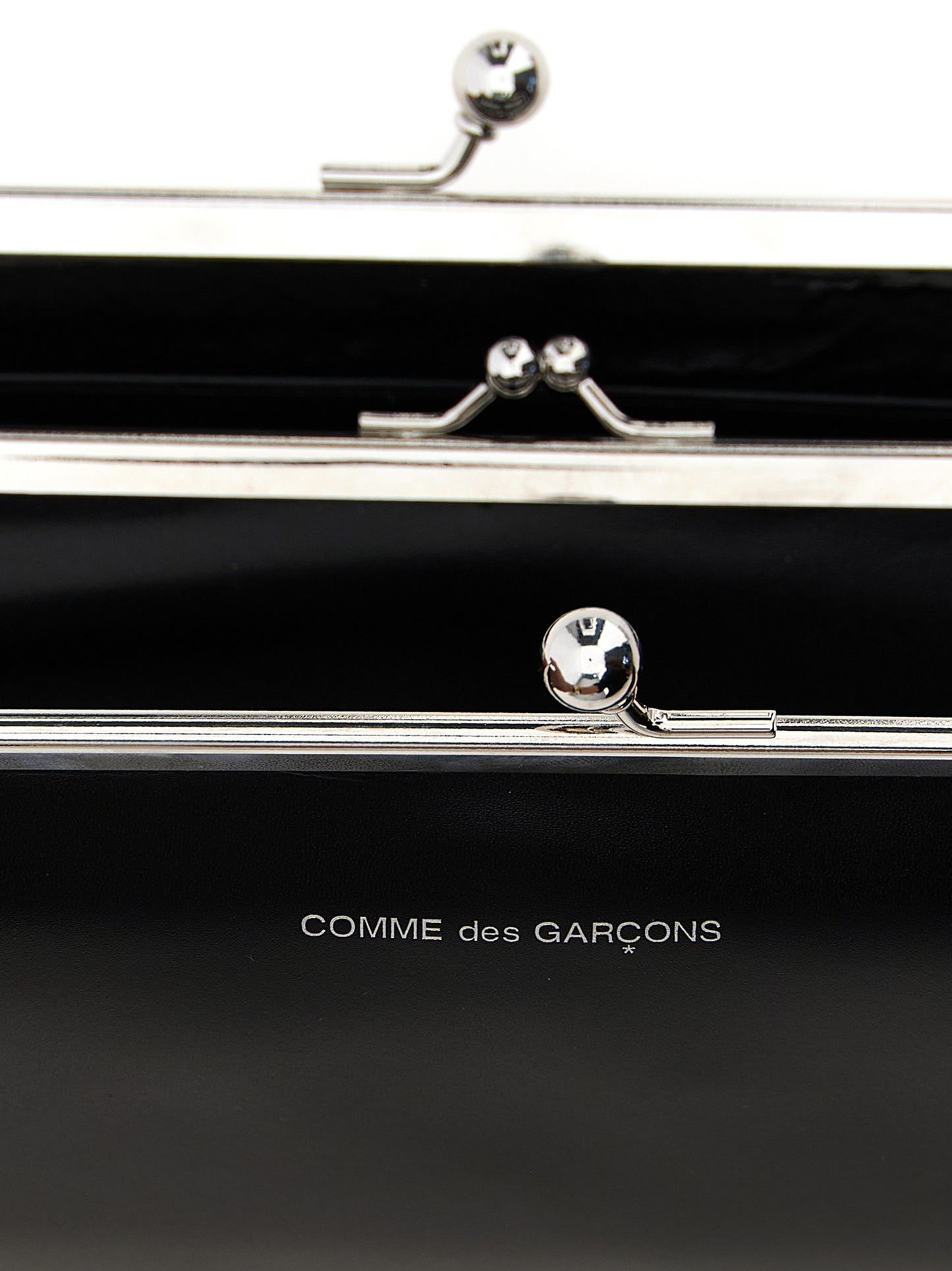 Wallet by Comme Des Garçons for men in leather black presents a refined silhouette, artfully capturing the essence of the Leather Wallet design with sophisticated compact-design coin-purse for a refined look.