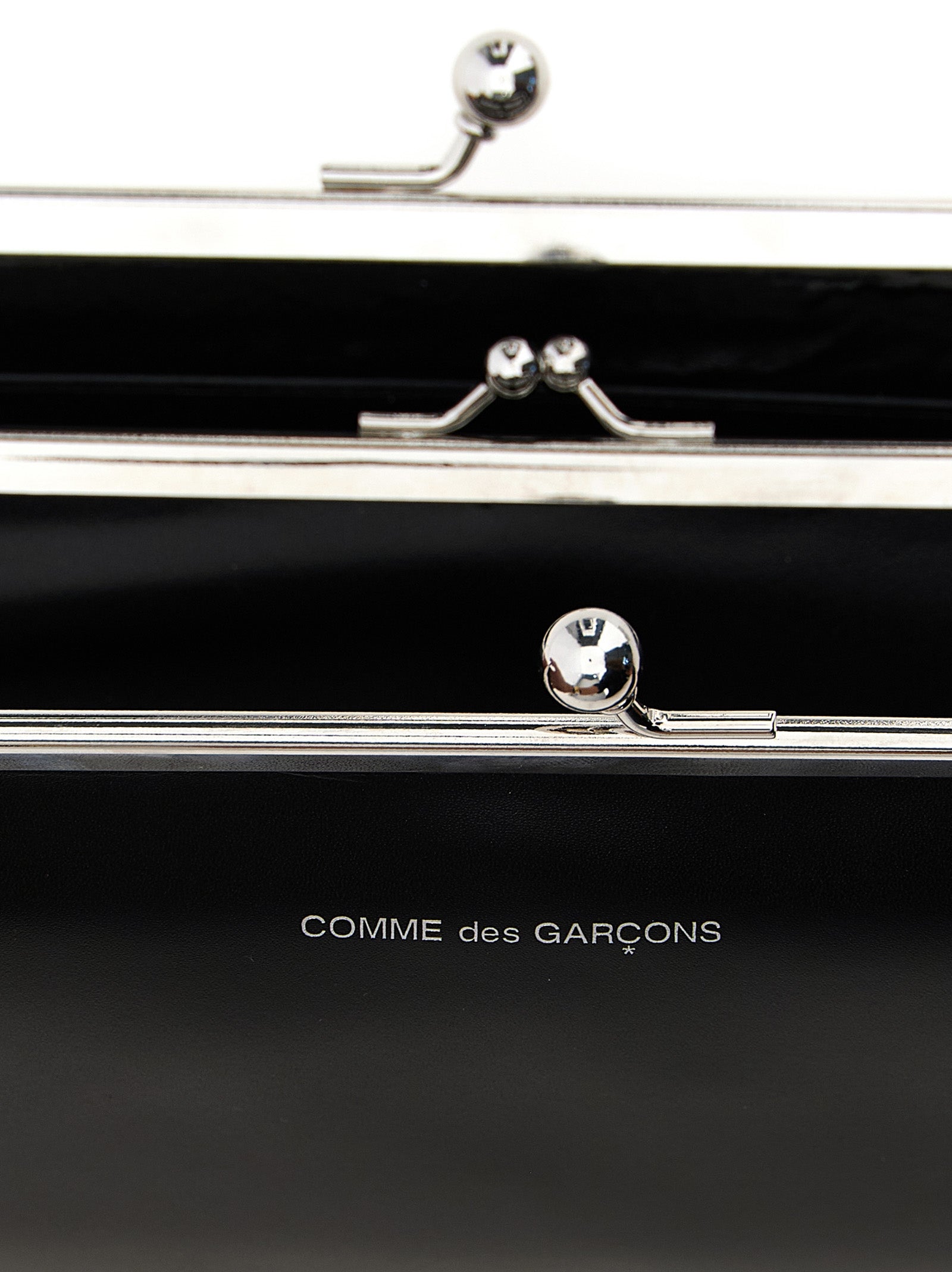 Wallet by Comme Des Garçons for men in leather black presents a refined silhouette, artfully capturing the essence of the Leather Wallet design with sophisticated compact-design coin-purse for a refined look.