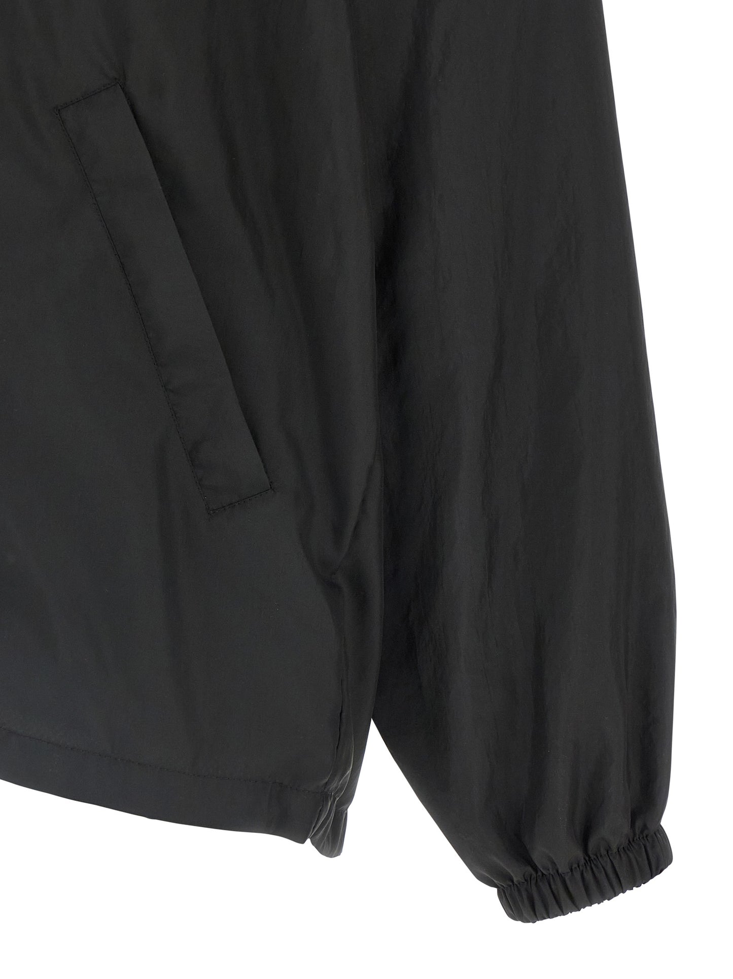 Hooded Windbreaker Jacket by Balenciaga for men in polyester black presents a resilient silhouette, artfully detailed with a sophisticated and functional hooded & windproof for a resilient finish.
