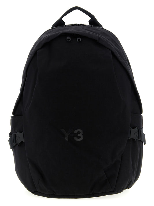 Backpack by Y-3 for unisex in coated canvas black showcases a stately Cordura Coated Canvas Backpack design, featuring a secure zipper with stately and versatile backpack-strap, adjustable-strap & handle.