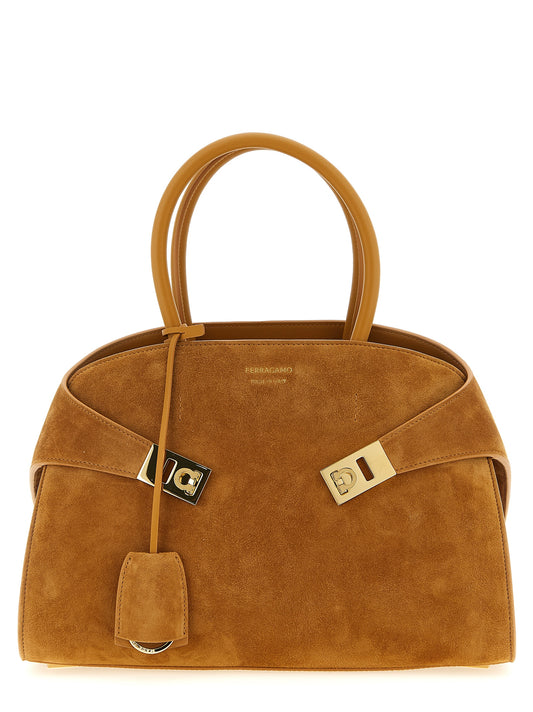 Handbag by Ferragamo for women in suede leather beige presents a ornamental silhouette, showcasing a secure , ample , and versatile shoulder-strap & adjustable-strap for a ornamental finish.