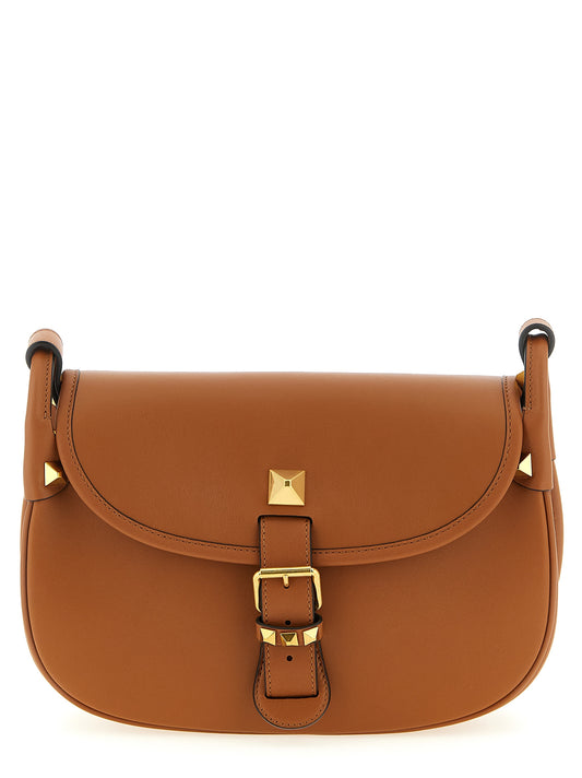 Medium Shoulder Flap Bag by Valentino Garavani for women in calfskin leather brown & signature features a distinguished silhouette, showcasing a secure flap & magnetic and distinguished with versatile shoulder-strap & adjustable-strap for a distinguished finish.