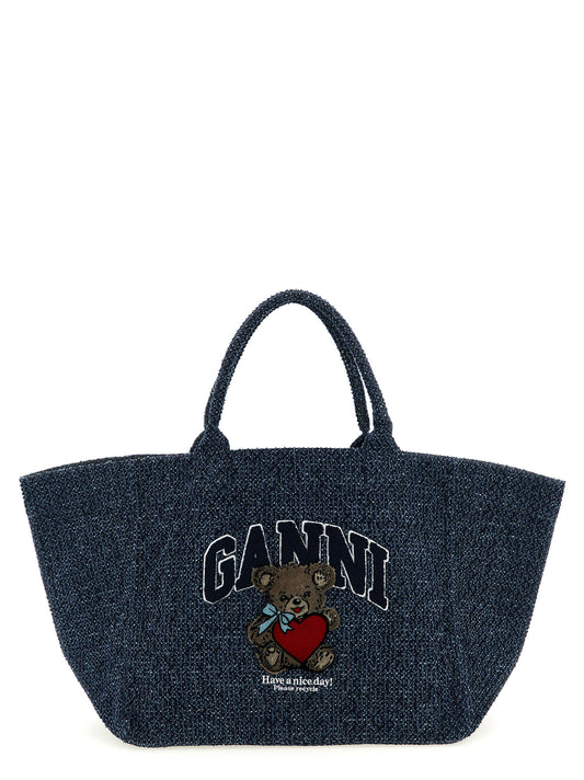 Shopper Tote Bag by Ganni for women in tweed organic cotton denim blue features an utilitarian-chic silhouette, showcasing the Bear Tweed Organic Cotton Denim Shopper Tote Bag design with a secure , ample , and versatile handle.