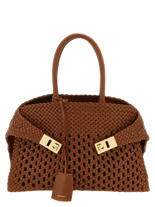 Handbag by Ferragamo for women in calfskin leather brown features a signature silhouette, showcasing a secure and signature with versatile shoulder-strap, adjustable-strap & handle for a sophisticated look.
