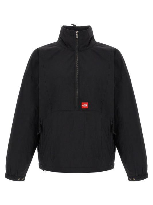 Windbreaker Jacket by The North Face for men in nylon black & red presents a resilient silhouette, artfully detailed with a sophisticated high-neck neckline and functional pockets & windproof for a resilient finish.