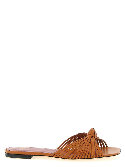 Sliders Sandals Flat Shoes by Valentino Garavani for women in goatskin leather & brass brown & signature features an captivating silhouette, showcasing the captivating style of the V Logo Women's Goatskin Leather & Brass Sliders Sandals Flat Shoes with its distinct and refined square toe style.