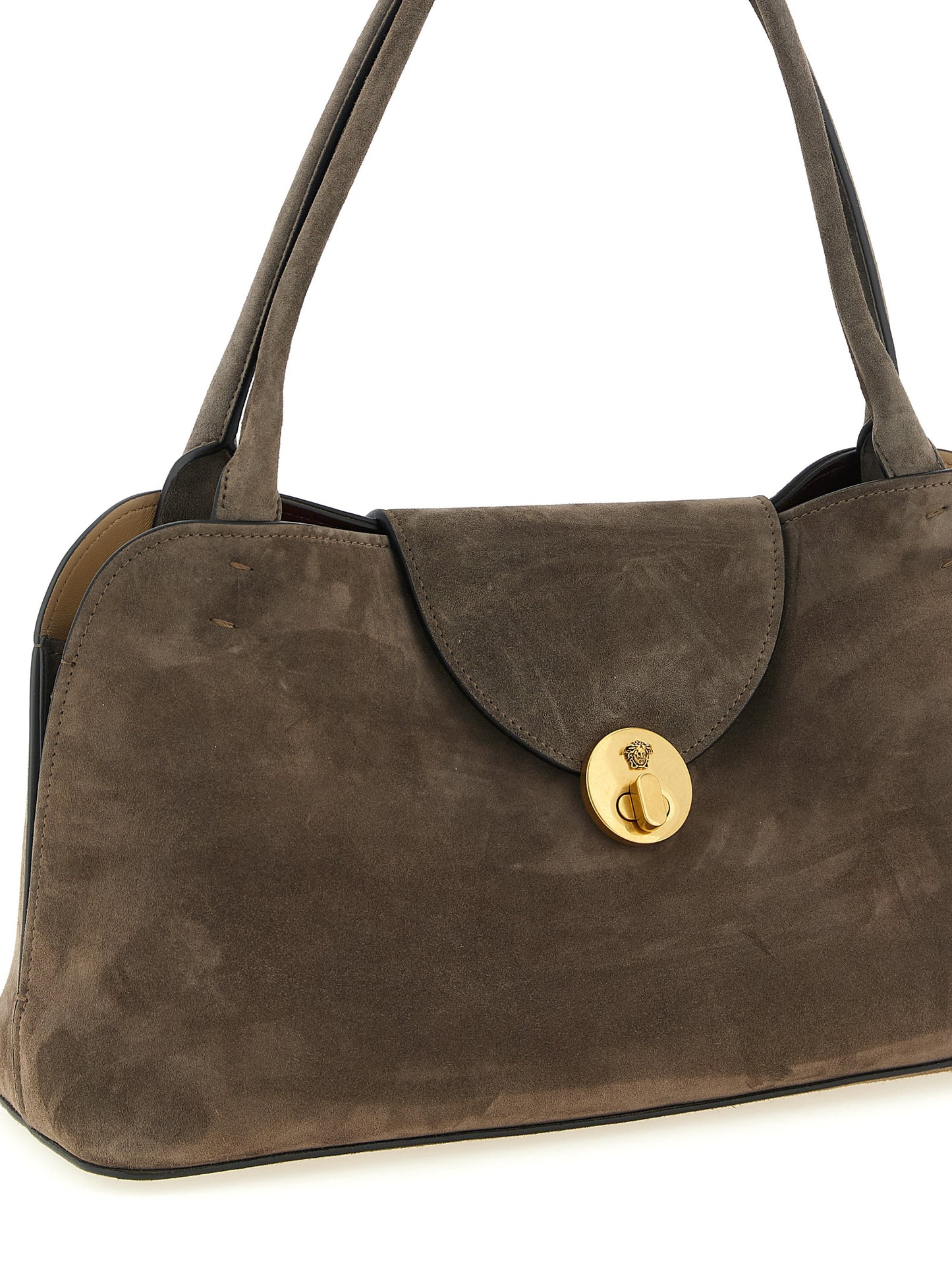 Medium Shoulder East West Flap Bag by Versace for women in calfskin & lambskin leather brown features a enviable silhouette, showcasing a secure flap, ample built-in-compartments, and enviable shoulder-strap & handle for a enviable finish.