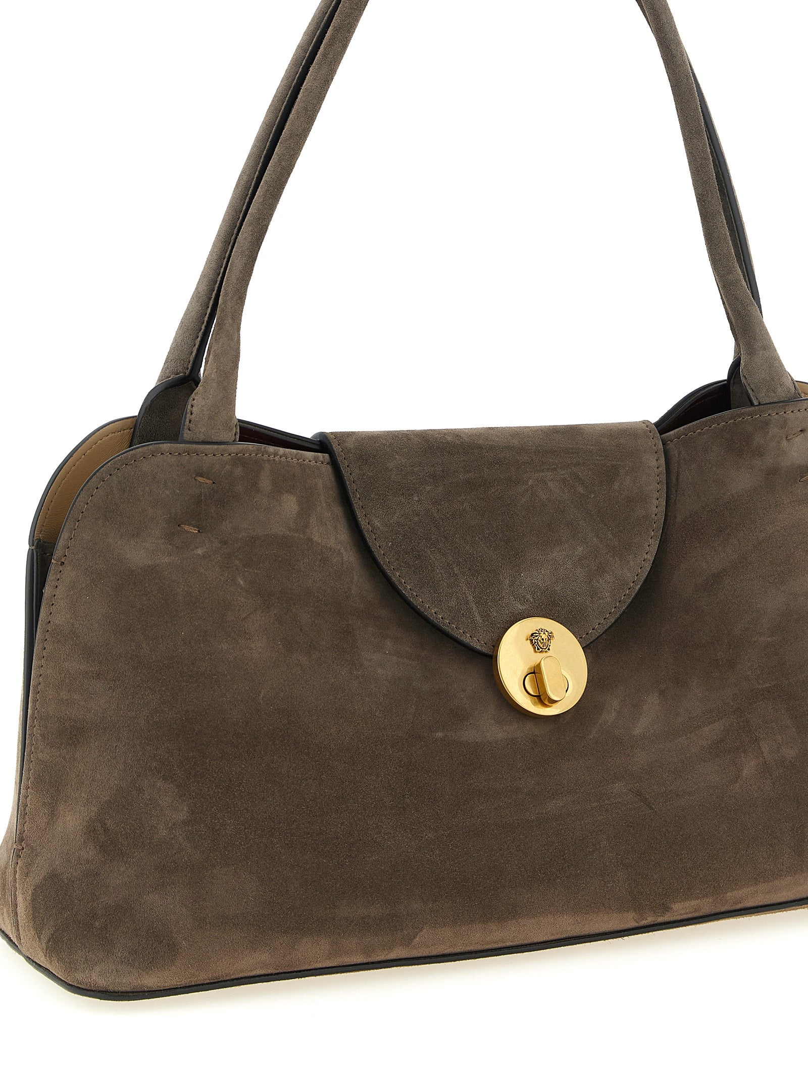 Medium Shoulder East West Flap Bag by Versace for women in calfskin & lambskin leather brown features a enviable silhouette, showcasing a secure flap, ample built-in-compartments, and enviable shoulder-strap & handle for a enviable finish.
