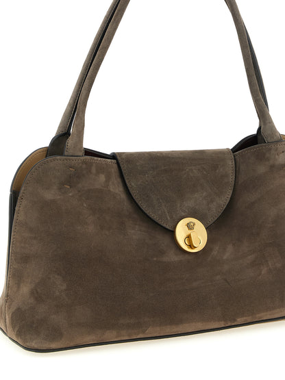 Medium Shoulder East West Flap Bag by Versace for women in calfskin & lambskin leather brown features a enviable silhouette, showcasing a secure flap, ample built-in-compartments, and enviable shoulder-strap & handle for a enviable finish.