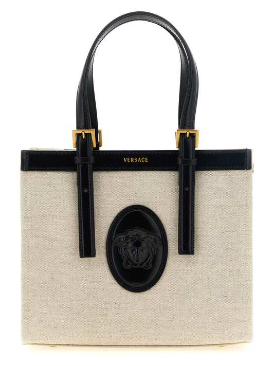 Mini Shopper Tote Bag by Versace for women in calfskin suede leather beige & print features a jet-set Medusa Riviere Calfskin Suede Leather Mini Shopper Tote Bag design, complete with a secure snap & button, ample , and versatile shoulder-strap, adjustable-strap & handle for a jet-set look.