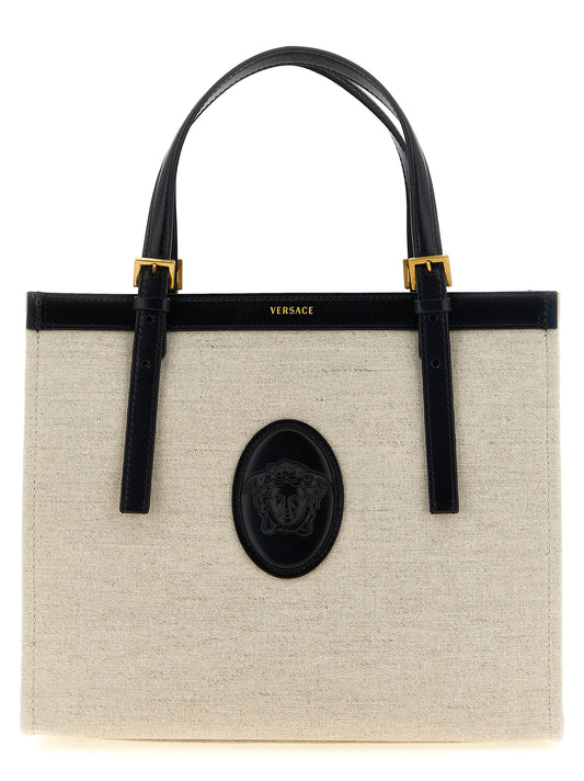 Medium Shopper Tote Bag by Versace for women in calfskin suede leather beige & print showcases a statuesque Medusa Riviere Calfskin Suede Leather Medium Shopper Tote Bag design, featuring a secure , ample built-in-compartments, and versatile shoulder-strap, adjustable-strap & handle for a statuesque finish.