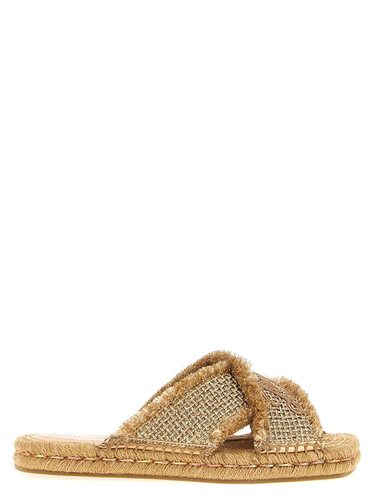 Sliders Sandals Flat Shoes by Jimmy Choo for women in lurex gold showcases a enchanting silhouette as part of the Women's Lurex Sliders Sandals Flat Shoes collection, defined by a enchanting square toe style and for a enchanting look.